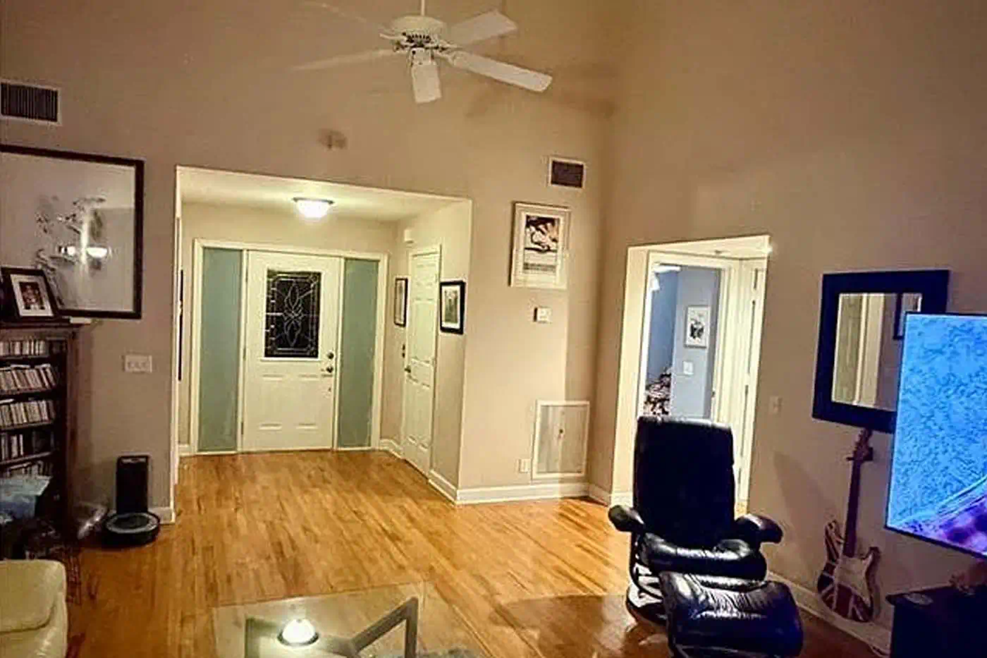 Open concept living room with high ceilings and hardwood floors at 5281 Teak Wood Drive, Logan Woods, Naples FL